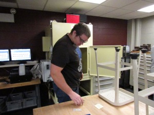 Another Ferris State student loads an X-ray machine for a weld test.